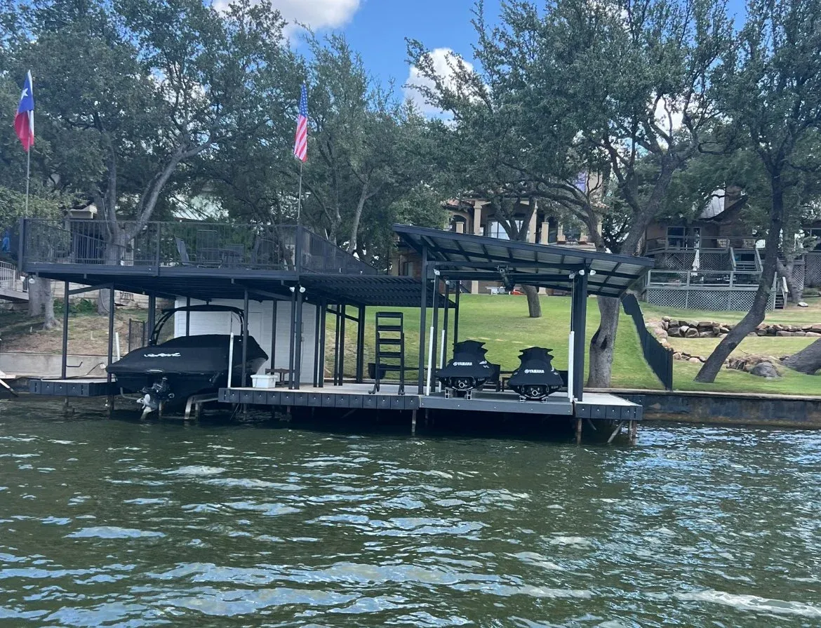 Double-slip stationary dock with steel roof and a boat on a lift
