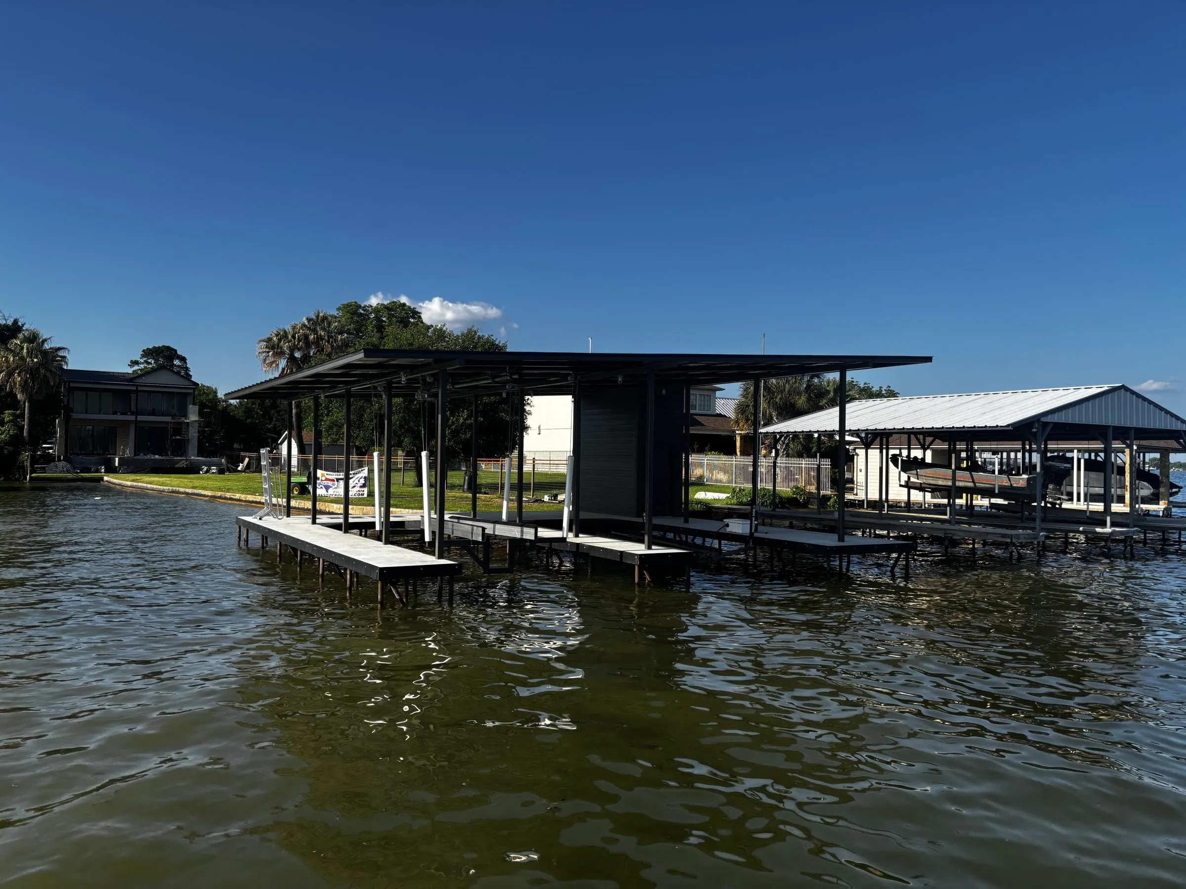 The boathouse seen from out on the lake, with neighboring docks along the shoreline