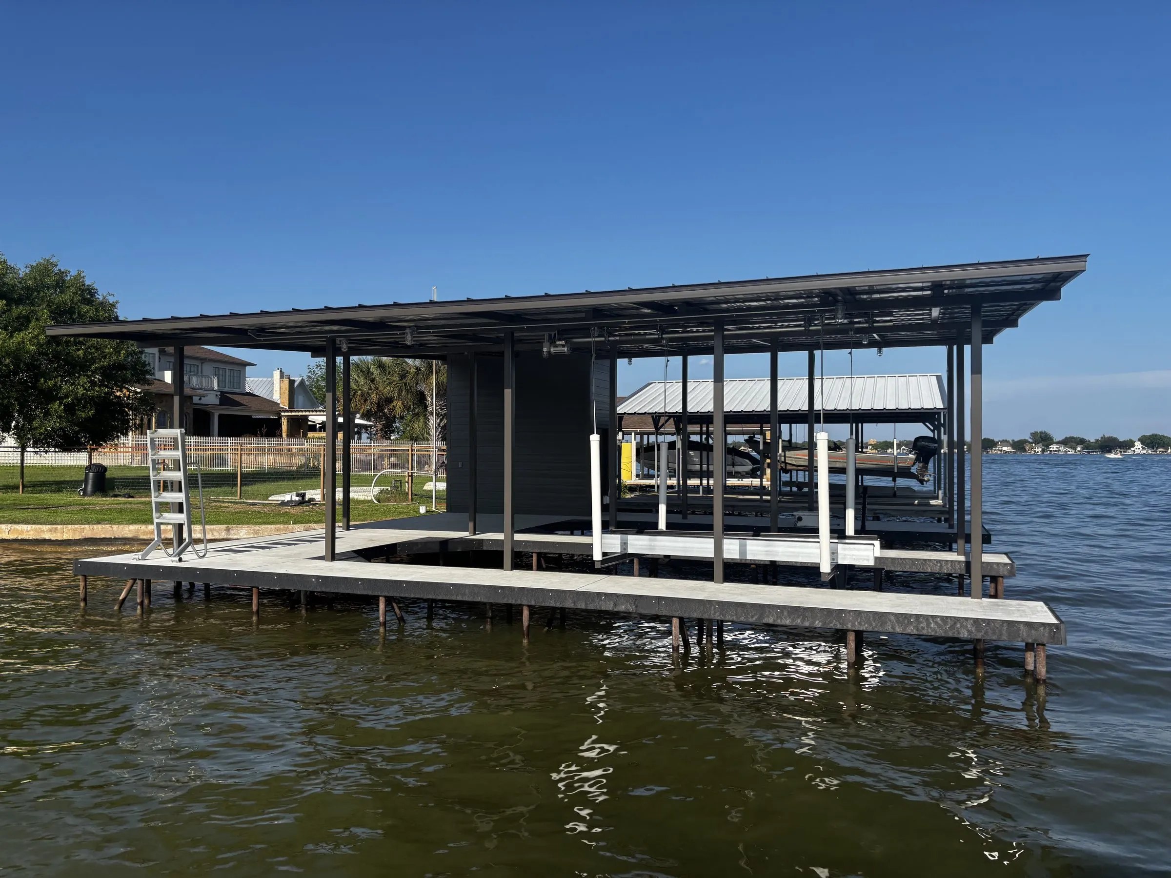Wide view of the full boathouse from the water