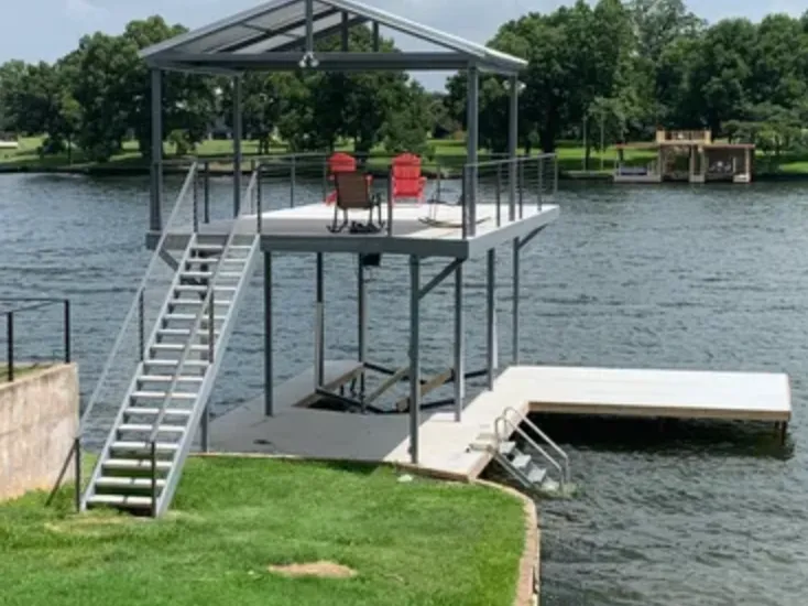 Two-level dock with steel stairs up to a covered rooftop sundeck